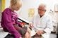 GP talking to young girl patient