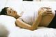 A pregnant women lying in bed