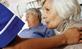 Man in hospital bed with unhappy woman and nurse at his side