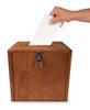A voter putting a vote into a ballot box