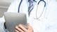 Doctor using electronic tablet device