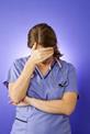 Female nurse with hand across her face
