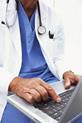 A doctor using a medical laptop