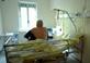 A patient sitting on the bed