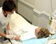 Nurse seeing to patient in hospital bed