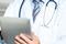Doctor using electronic tablet device